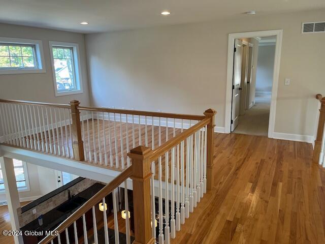 corridor with hardwood / wood-style floors