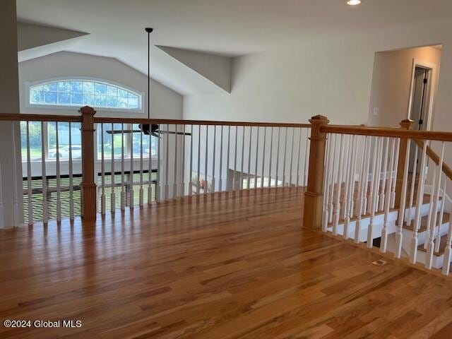 interior space featuring hardwood / wood-style flooring and vaulted ceiling