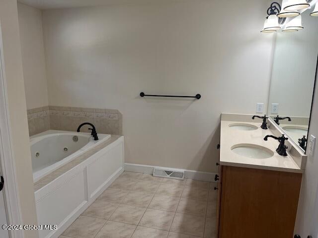 bathroom featuring tile patterned flooring, vanity, and a washtub