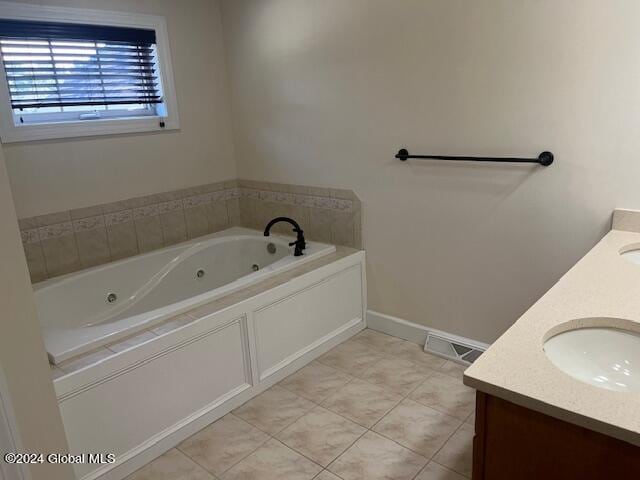 bathroom with vanity, tile patterned floors, and a washtub