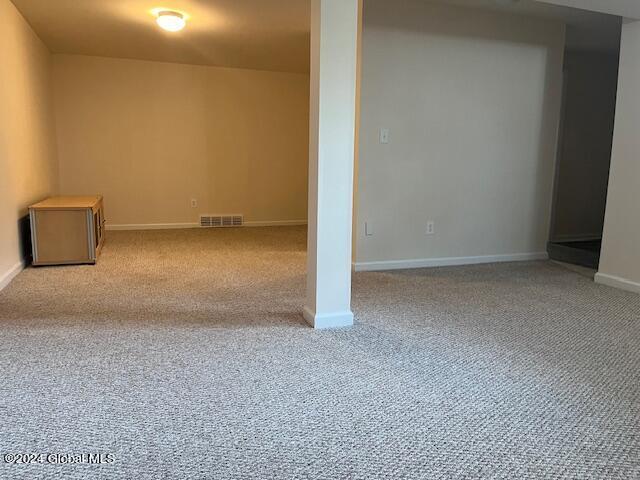 empty room featuring light carpet