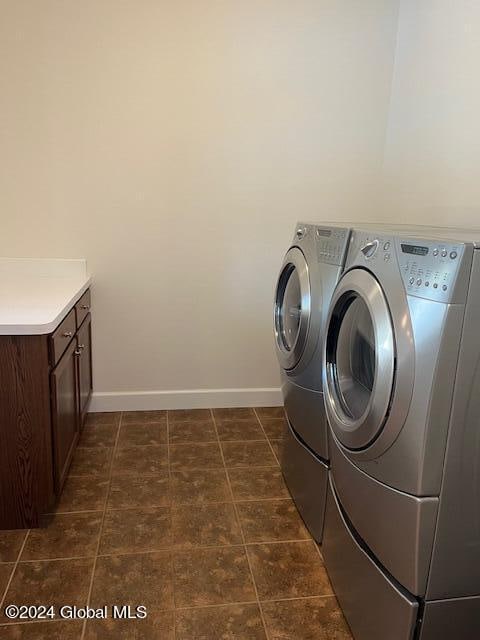 washroom featuring washer and dryer and cabinets