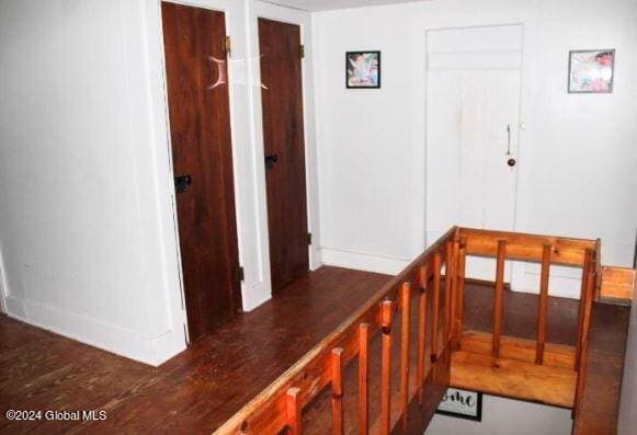 corridor with dark wood-type flooring