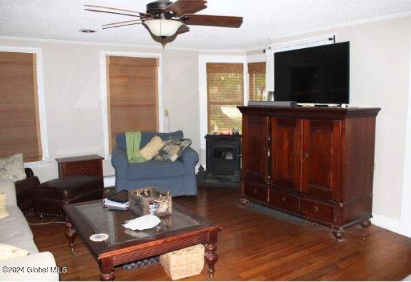 living room with ceiling fan, crown molding, and dark hardwood / wood-style flooring