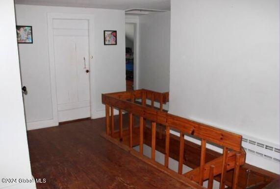 corridor featuring dark hardwood / wood-style floors