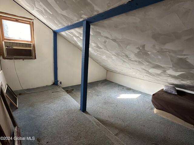 additional living space featuring carpet floors, cooling unit, and vaulted ceiling