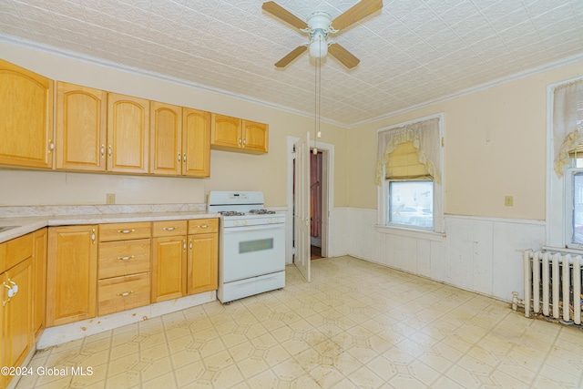 kitchen with white gas range oven, ornamental molding, ceiling fan, a textured ceiling, and radiator heating unit