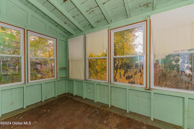 unfurnished sunroom featuring vaulted ceiling