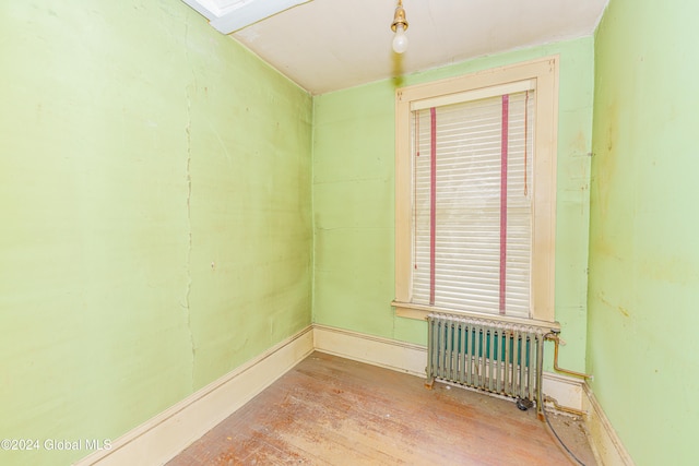 spare room with radiator and light hardwood / wood-style flooring