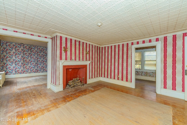 unfurnished living room with hardwood / wood-style floors and a fireplace