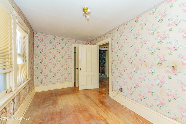 empty room with light hardwood / wood-style flooring