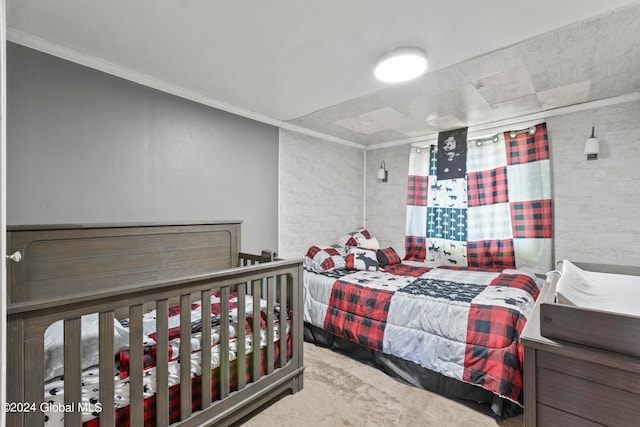 bedroom with ornamental molding and carpet