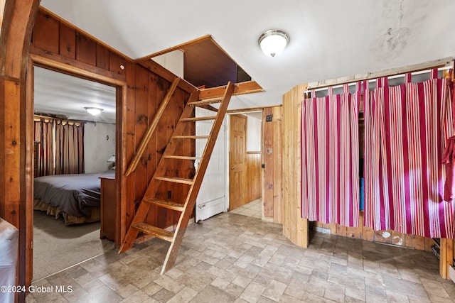 unfurnished bedroom with wooden walls