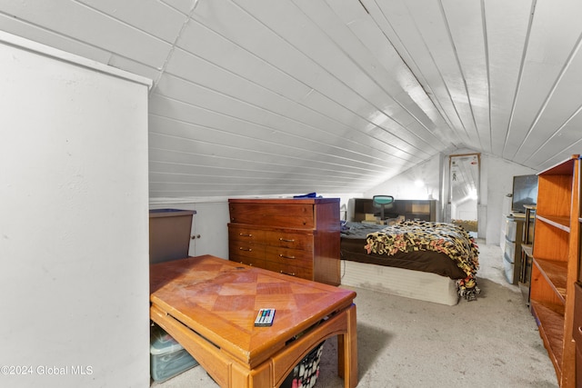 bedroom with light carpet and vaulted ceiling