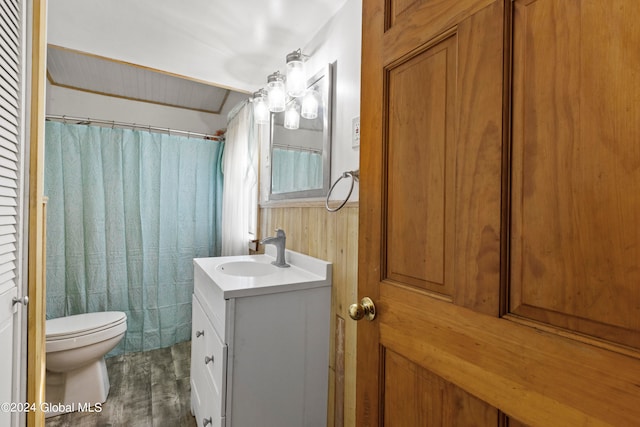 bathroom with wood-type flooring, a shower with curtain, vanity, and toilet