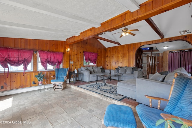 living room featuring a textured ceiling, wood walls, a baseboard radiator, vaulted ceiling with beams, and ceiling fan