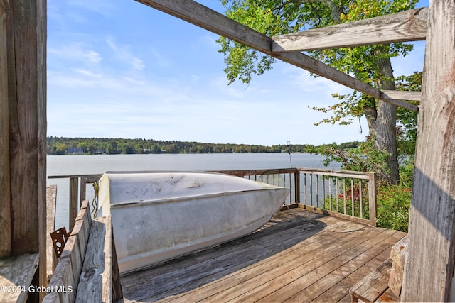 wooden terrace featuring a water view