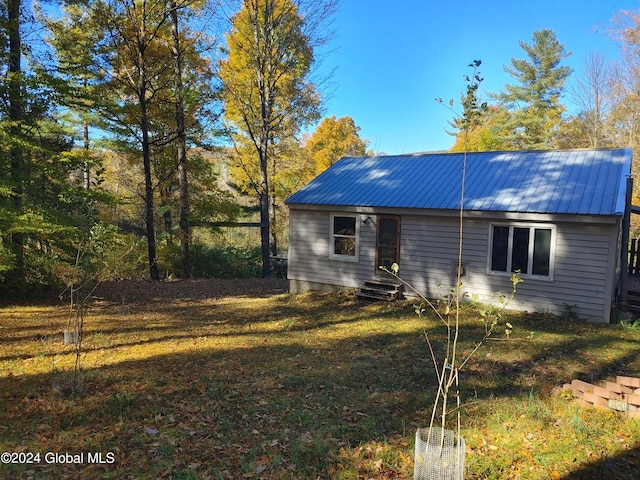 view of home's exterior with a yard