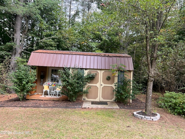 view of outbuilding with a lawn