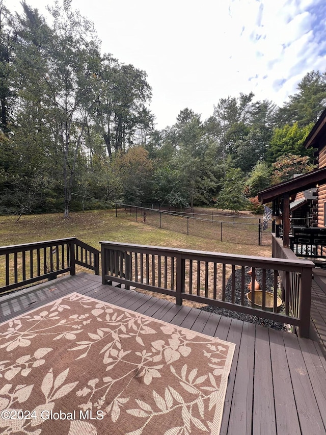 wooden terrace with a lawn