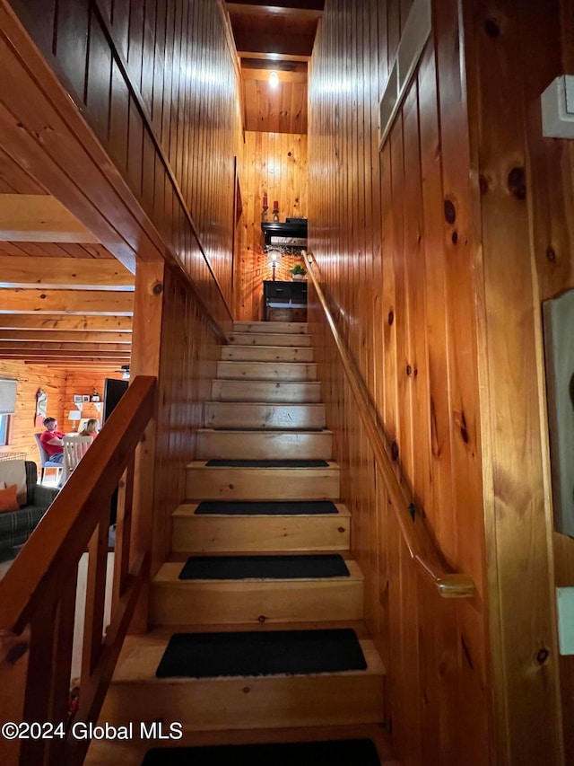 staircase with wood walls