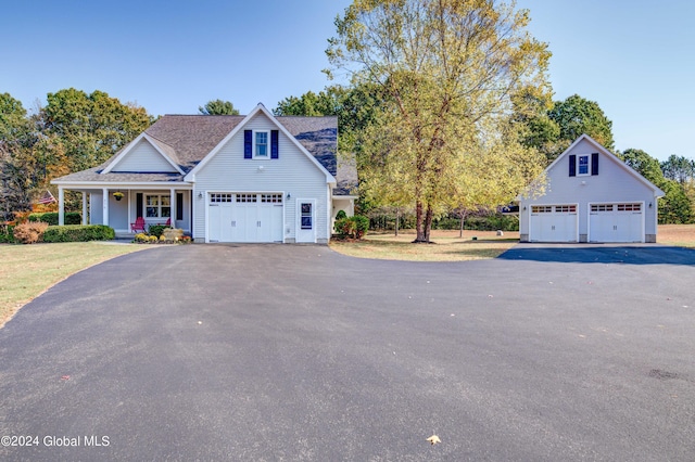 view of front of property featuring a garage, roof with shingles, and a porch