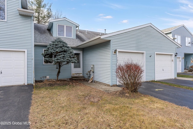 view of front facade with a front yard and a garage