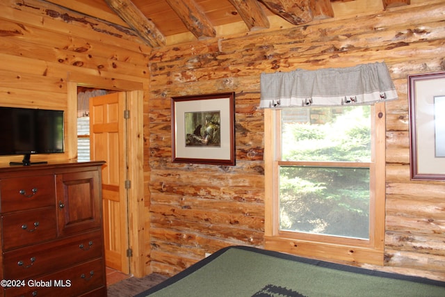 unfurnished bedroom featuring vaulted ceiling with beams, rustic walls, and wooden ceiling