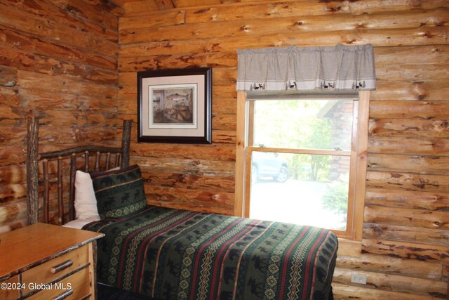 unfurnished bedroom with rustic walls