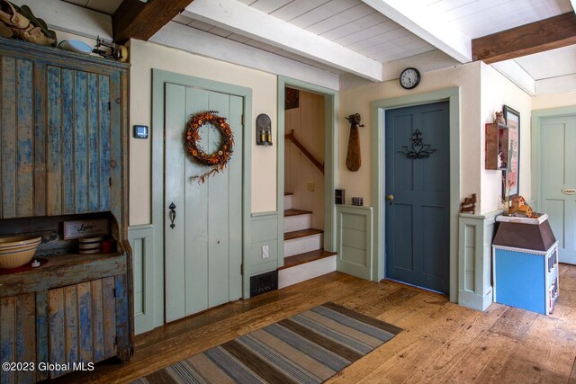 entrance foyer featuring wood-type flooring and beamed ceiling