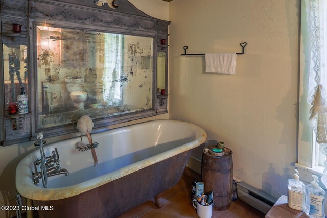 bathroom featuring a bath and baseboard heating