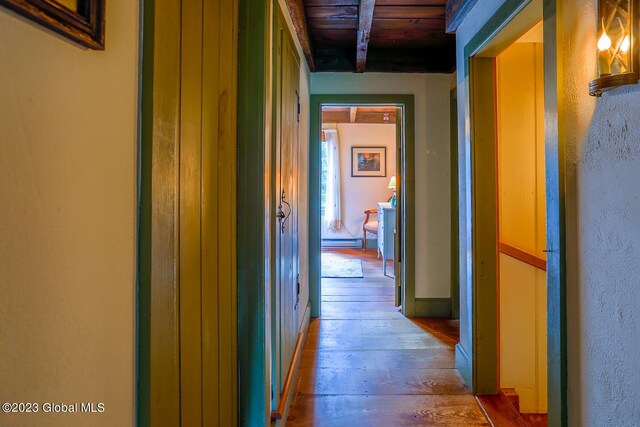 hall featuring wood-type flooring and wood ceiling