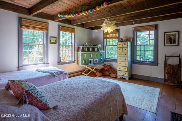 bedroom with beam ceiling, hardwood / wood-style flooring, and wooden ceiling