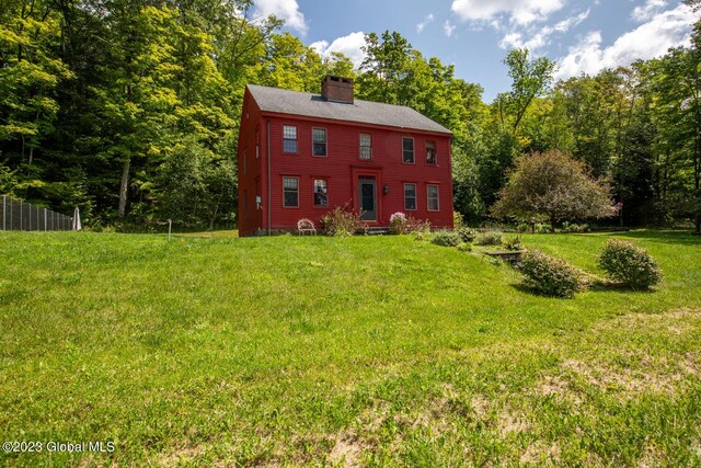 back of property featuring a lawn