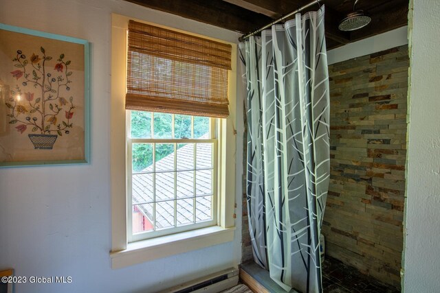 bathroom with plenty of natural light and curtained shower