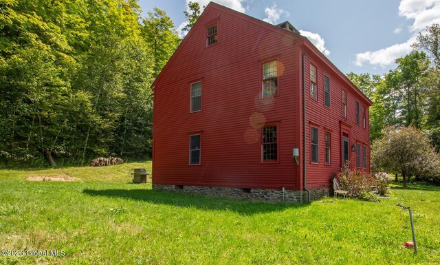 view of home's exterior with a yard