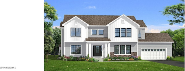 view of front of property featuring a garage and a front lawn