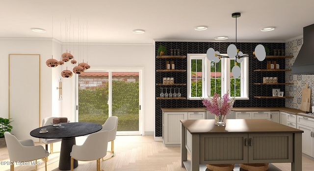 kitchen with white cabinetry, plenty of natural light, hanging light fixtures, and tasteful backsplash