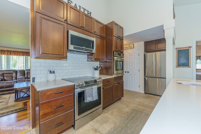 kitchen featuring stainless steel appliances and decorative backsplash