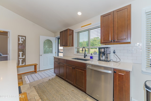 kitchen featuring vaulted ceiling, sink, tasteful backsplash, and stainless steel dishwasher