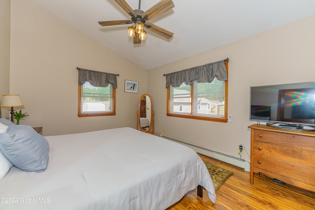 bedroom featuring a baseboard radiator, light wood-type flooring, vaulted ceiling, and ceiling fan