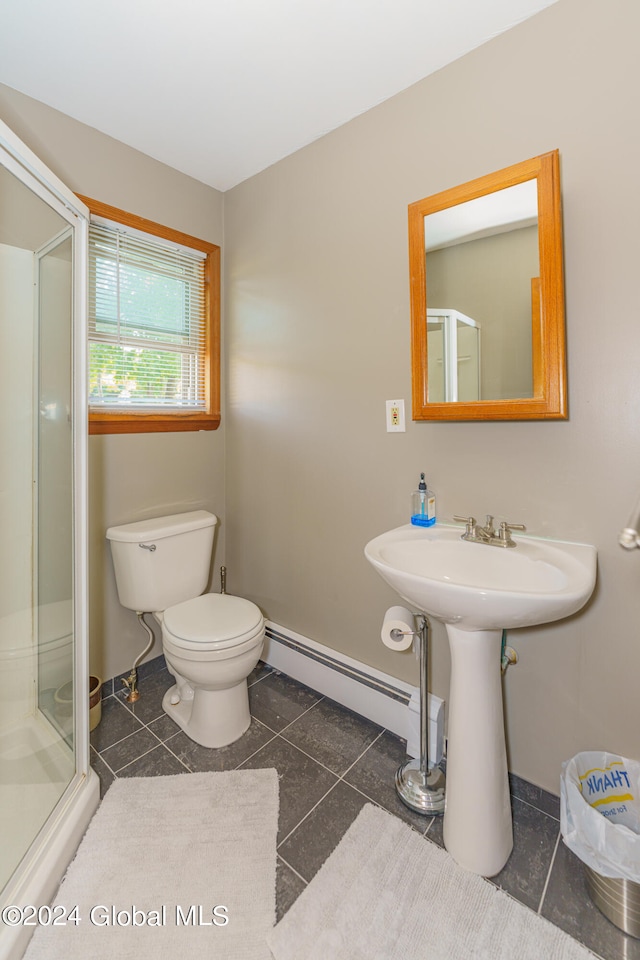 bathroom featuring walk in shower, tile patterned flooring, toilet, and a baseboard heating unit