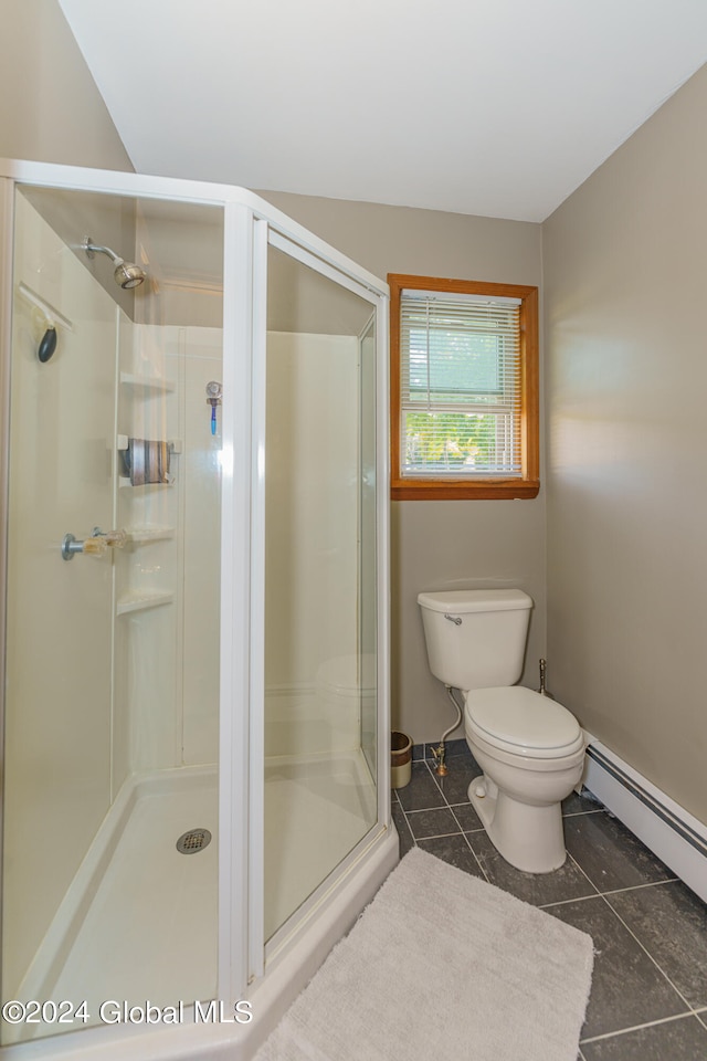 bathroom with tile patterned flooring, toilet, a baseboard radiator, and a shower with shower door