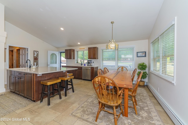 dining area with vaulted ceiling, sink, a baseboard radiator, and plenty of natural light