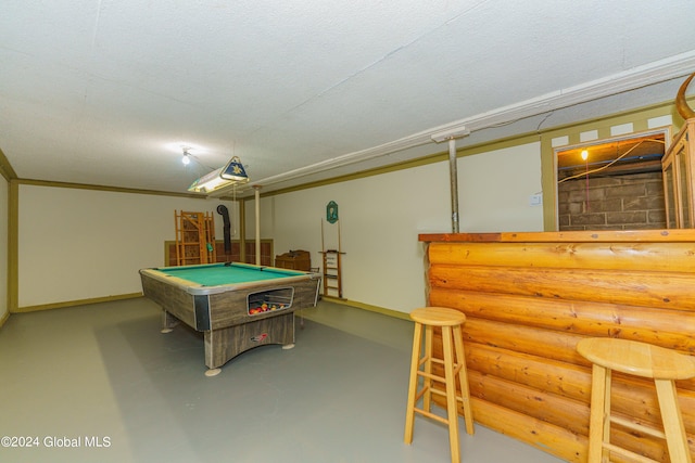 playroom with ornamental molding, a textured ceiling, bar area, and billiards