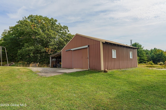 view of outbuilding with a lawn