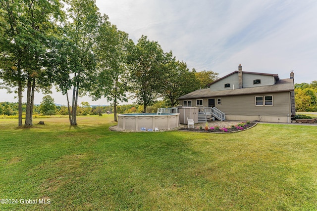 view of yard with a swimming pool side deck