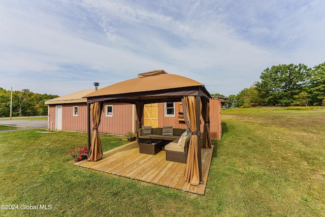 rear view of property with a gazebo, a yard, and an outdoor living space