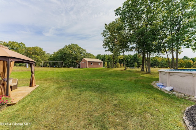 view of yard featuring a swimming pool side deck and a gazebo