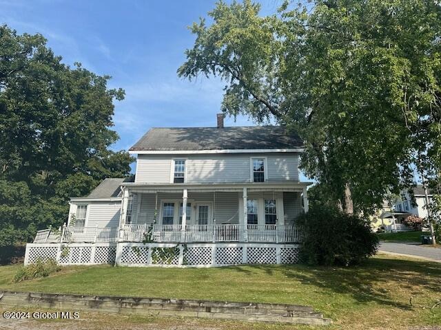 view of front of house featuring a front lawn and covered porch